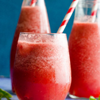mexican watermelon agua fresca served in glasses and bottles with red and white straws