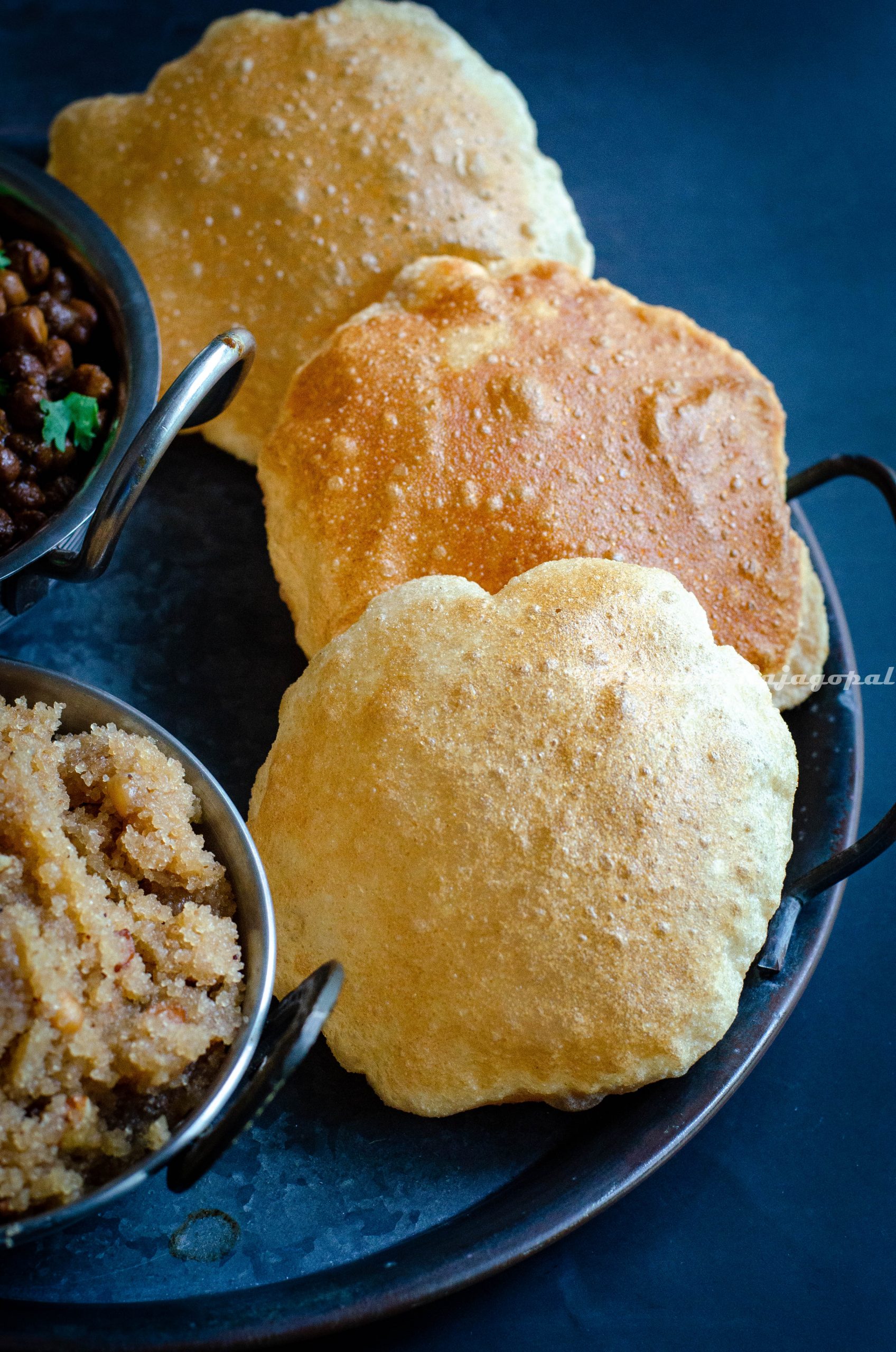 Fluffy golden poori served with Ashtami prasad and halwa