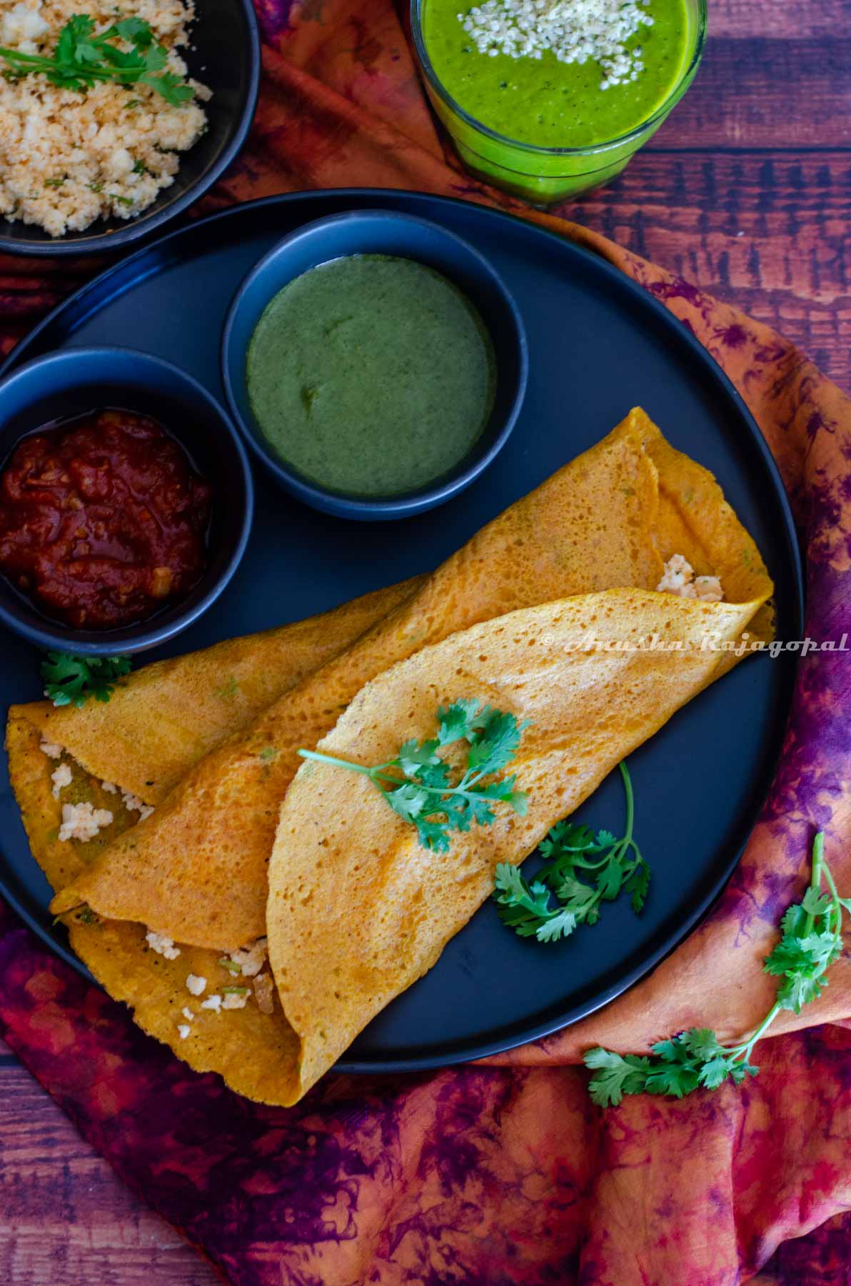 Moong dal cheelas stuffed with paneer and served with chutneys and a smoothie