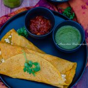 Moong dal cheelas stuffed with paneer and served with chutneys and a smoothie