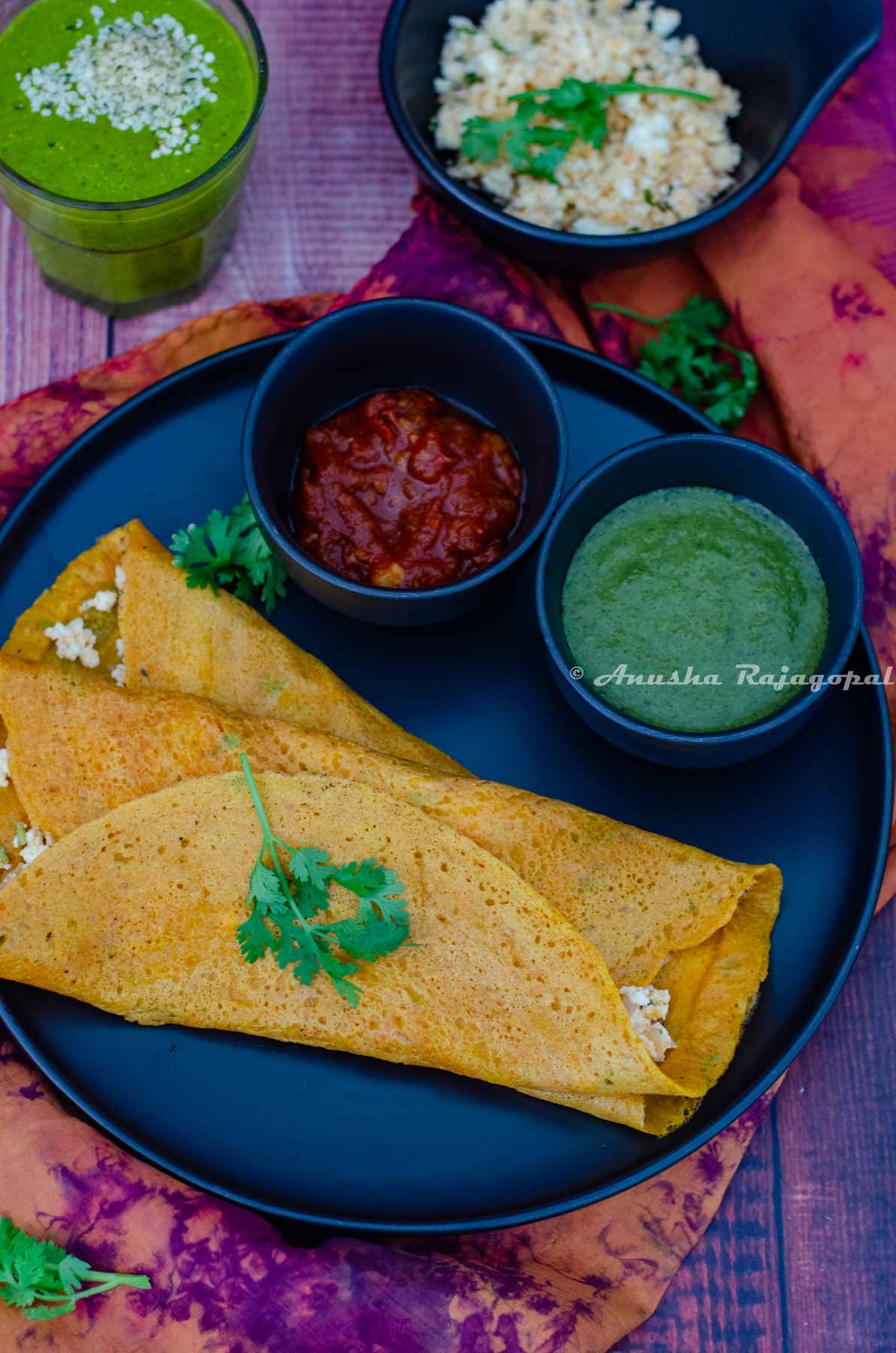 Moong dal cheelas stuffed with paneer and served with chutneys and a smoothie