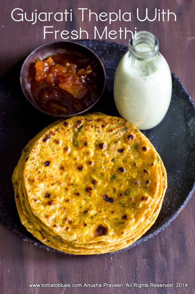 methi thepla,an Indian flatbread stacked and served with buttermilk and pickles