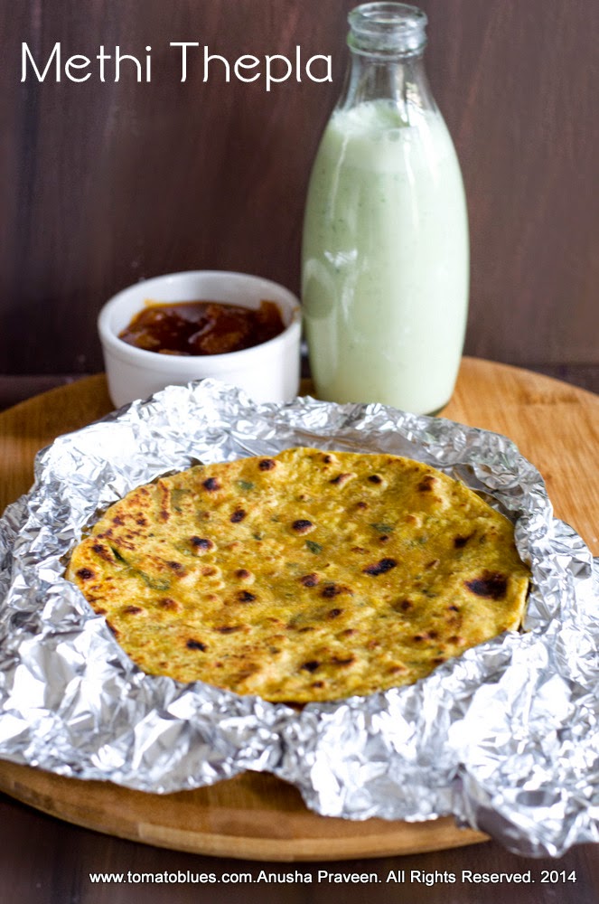 methi thepla,an Indian flatbread stacked and served with buttermilk and pickles