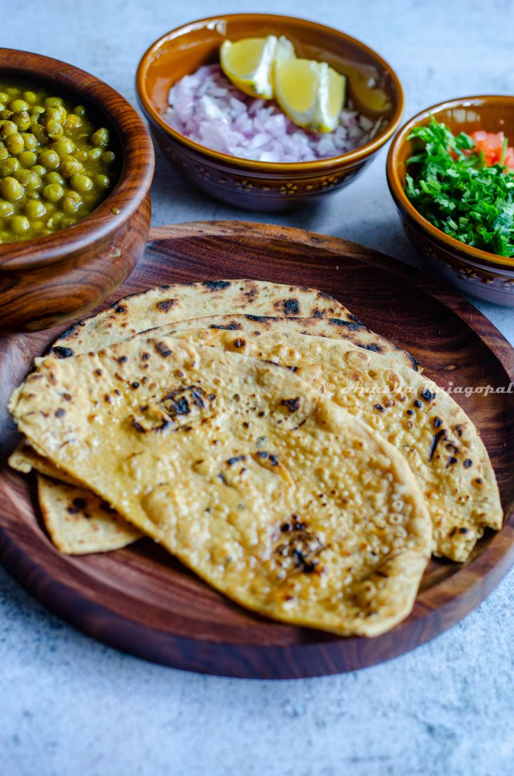 whole wheat kulcha served on a wooden platter