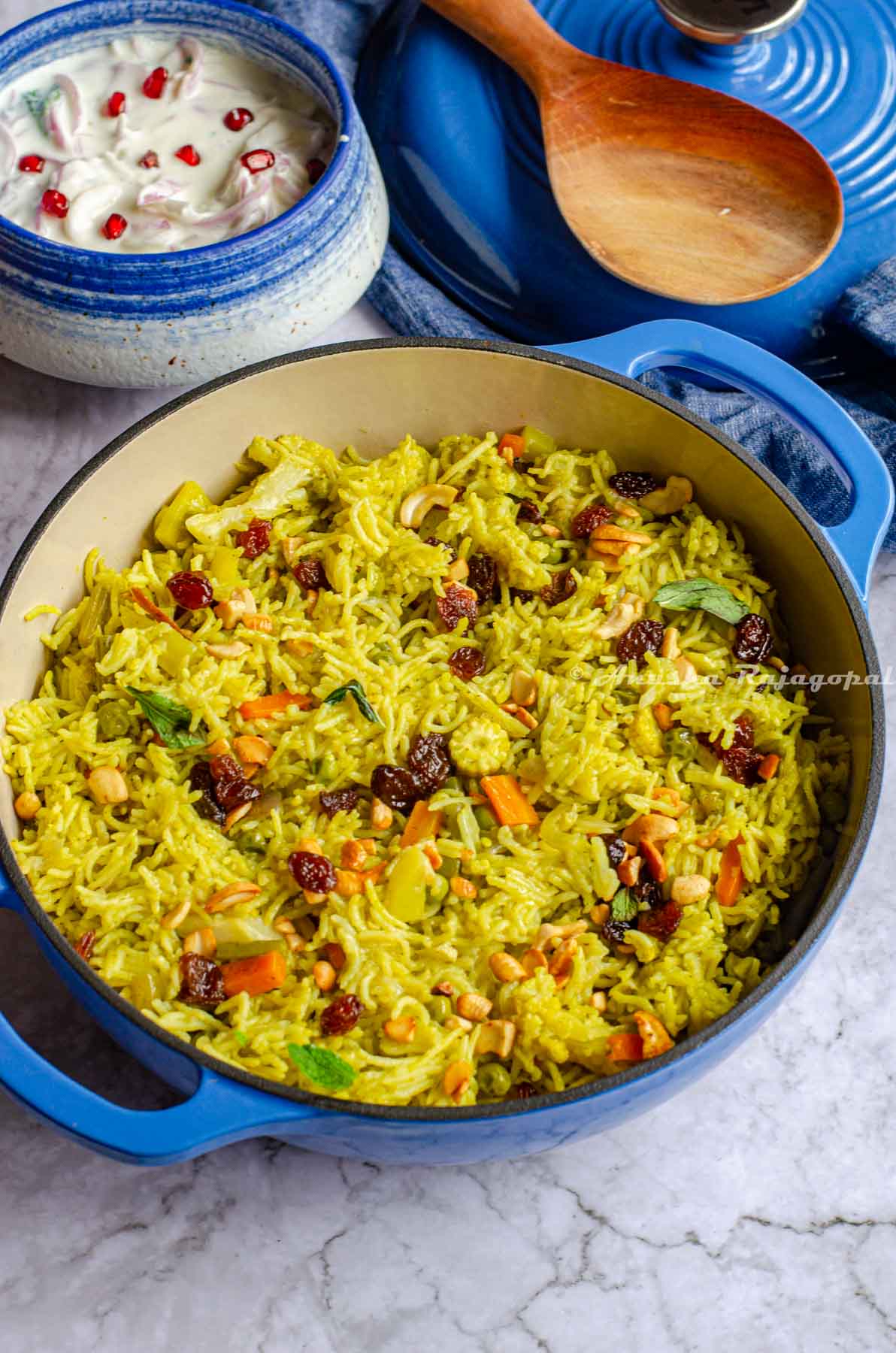 vegetable biryani made in the Instant pot and served in a blue cast iron enameled dutch oven