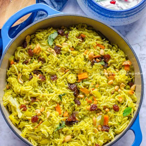 vegetable biryani made in the Instant pot and served in a blue cast iron enameled dutch oven