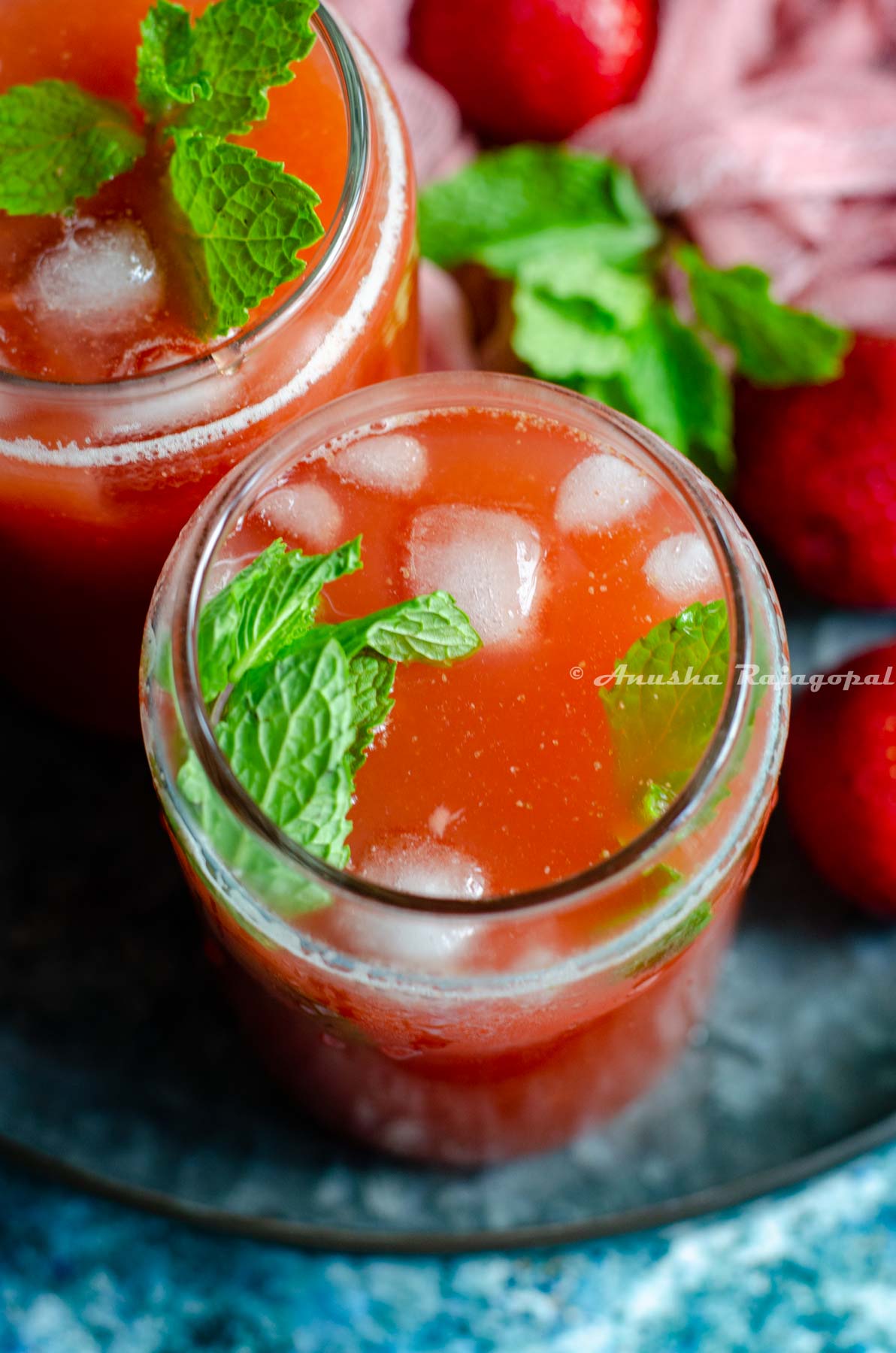 fresh strawberry lemonade served over ice and fresh mint sprigs.