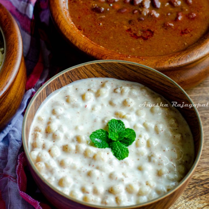 Boondi raita garnished with mint leaves and served in a wooden bowl