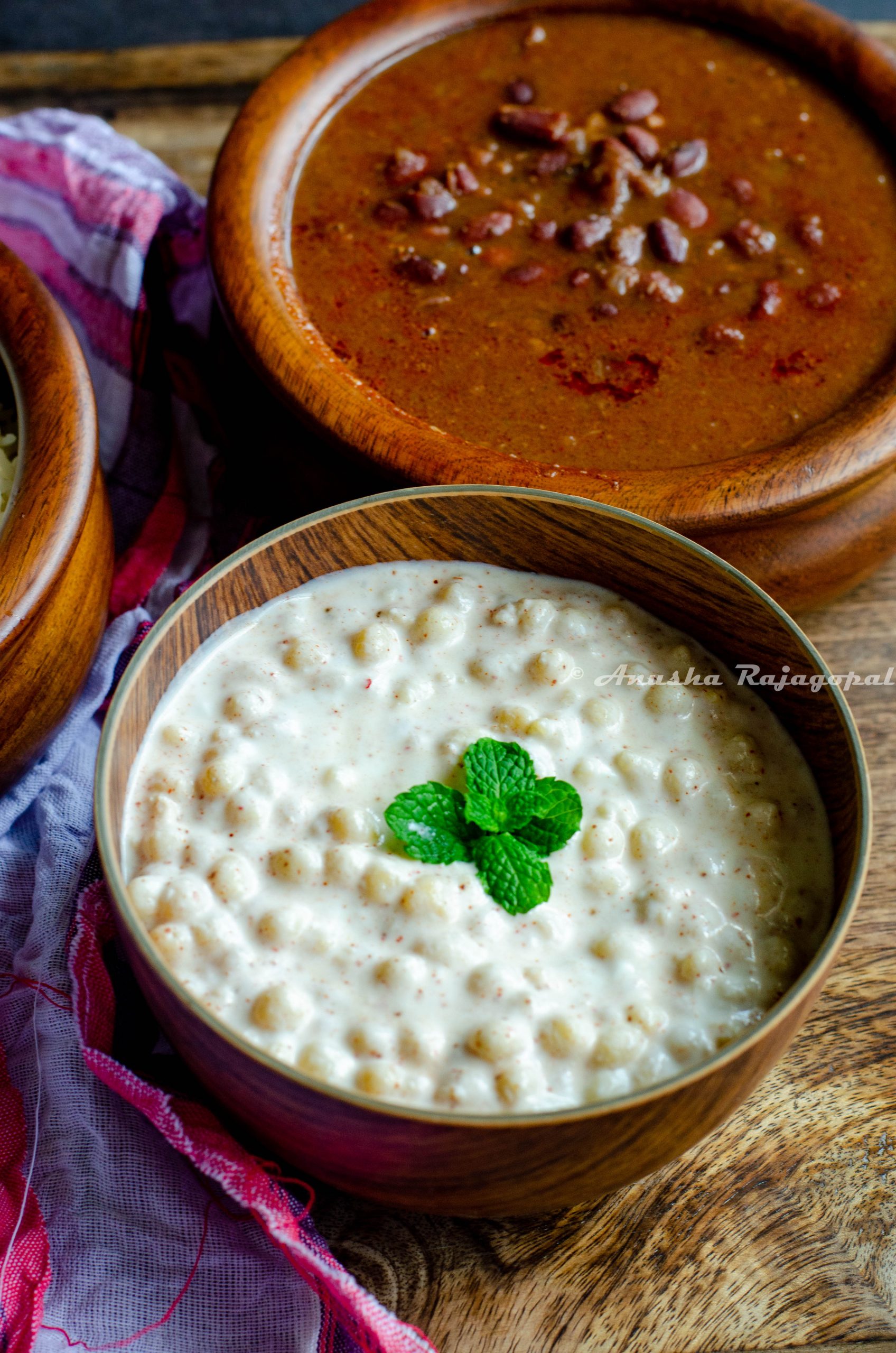 Boondi raita garnished with mint leaves and served in a wooden bowl