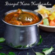 brinjal kara kuzhambu served with fryums at the backdrop