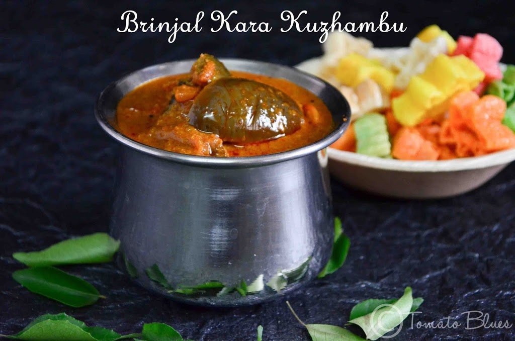 brinjal kara kuzhambu served with fryums at the backdrop