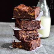 a stack of eggless dulce de leche brownies served with milk