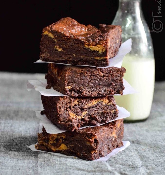 a stack of eggless dulce de leche brownies served with milk
