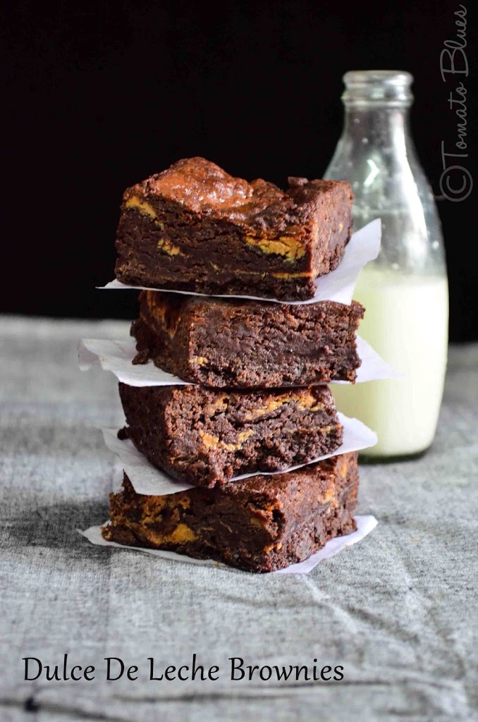 a stack of eggless dulce de leche brownies served with milk