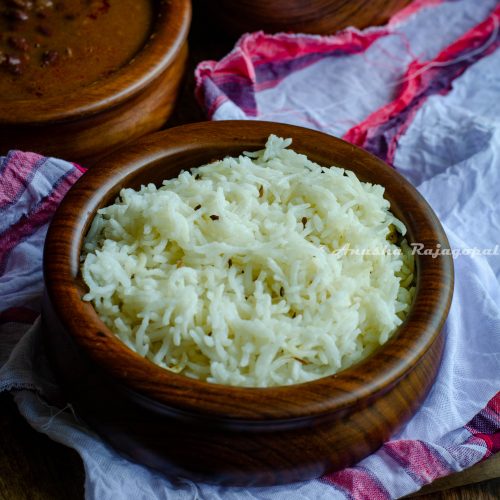 easy open pan jeera rice served in a bowl placed on a white cotton cloth