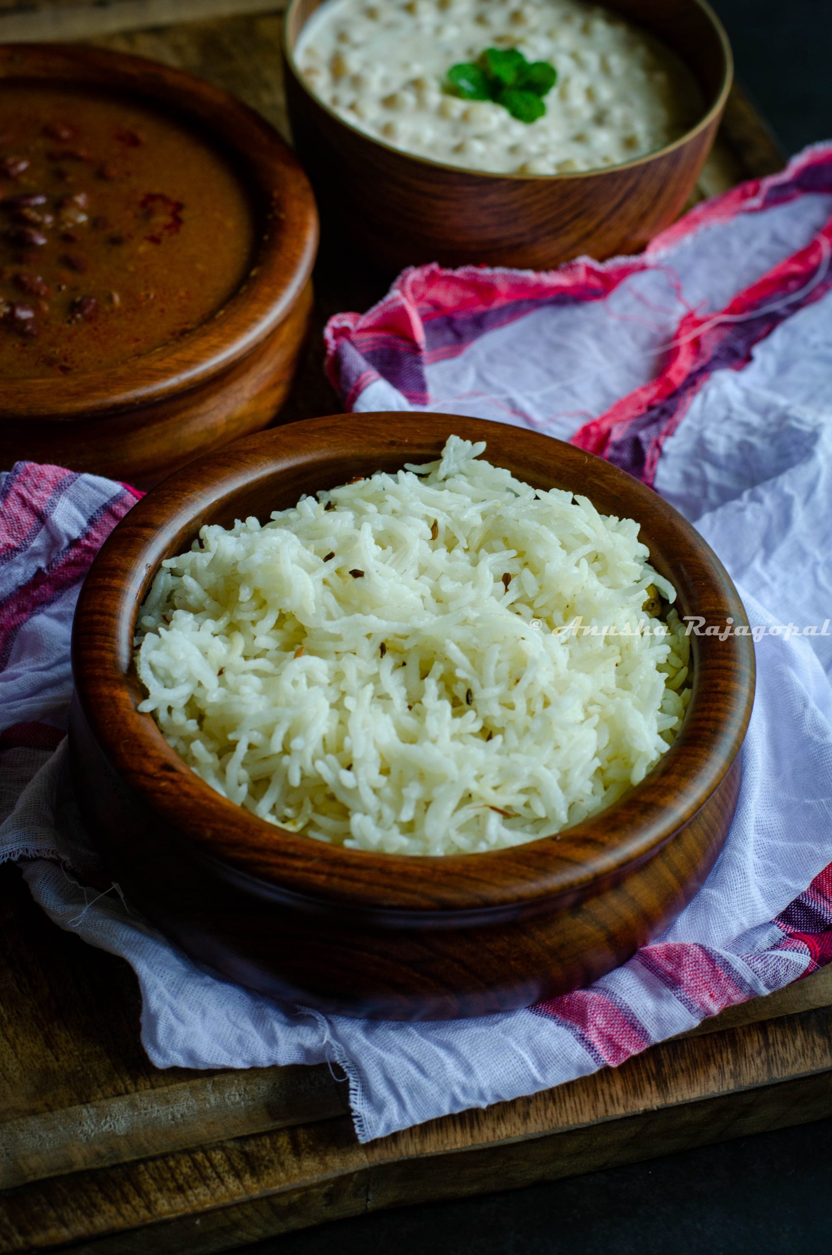 easy open pan jeera rice served in a bowl placed on a white cotton cloth