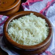 jeera rice served in a brown bowl and placed in a platter with rajma masala and boondi raita