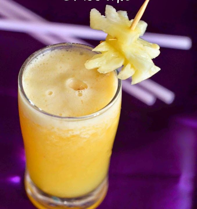 Pineapple Ginger Orange Smoothie Served in a glass on a purple background