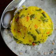 Rava kichdi placed in a pool of coconut chutney