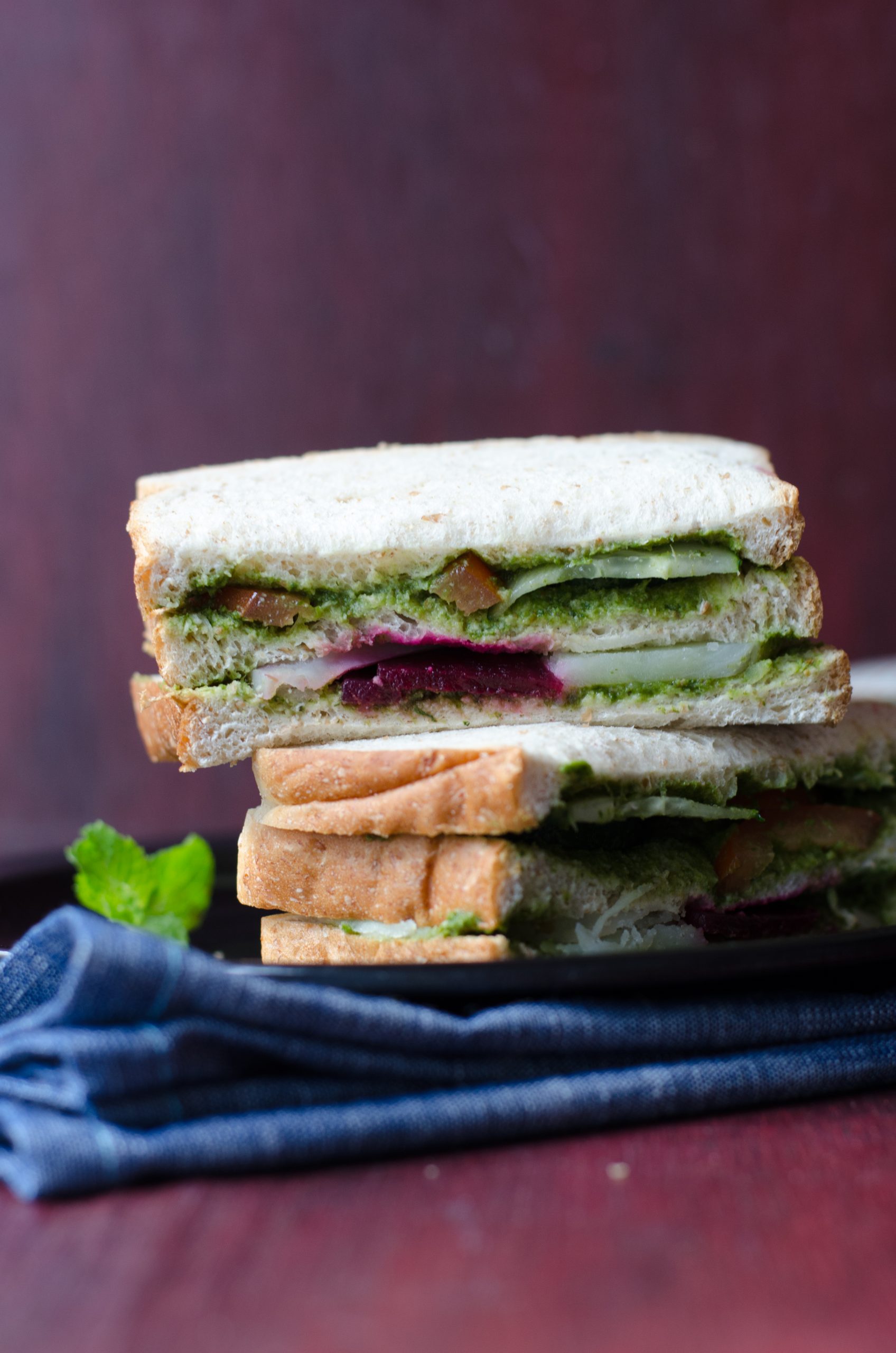 bombay sandwich stacked and served on a black plate