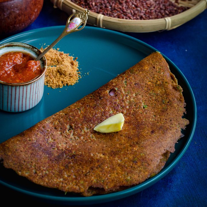 mapillai samba adai served on a turquoise blue plate against a blue backdrop