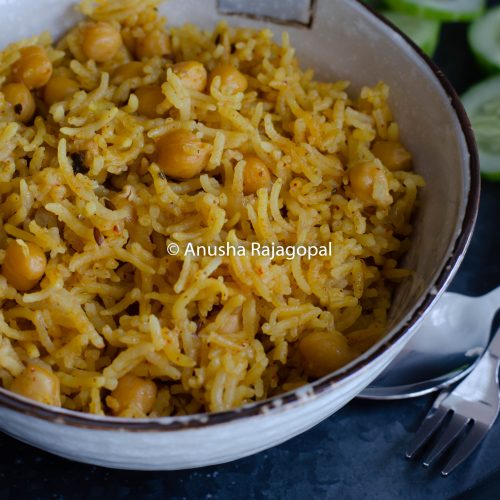 chana pulao in mealthy served in a beige bowl with cukes and raita.