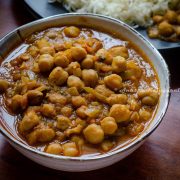 Punjabi chole masala served in a white bowl with steamed rice