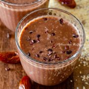 vegan coffee banana smoothie topped with cacao nibs and served in glasses