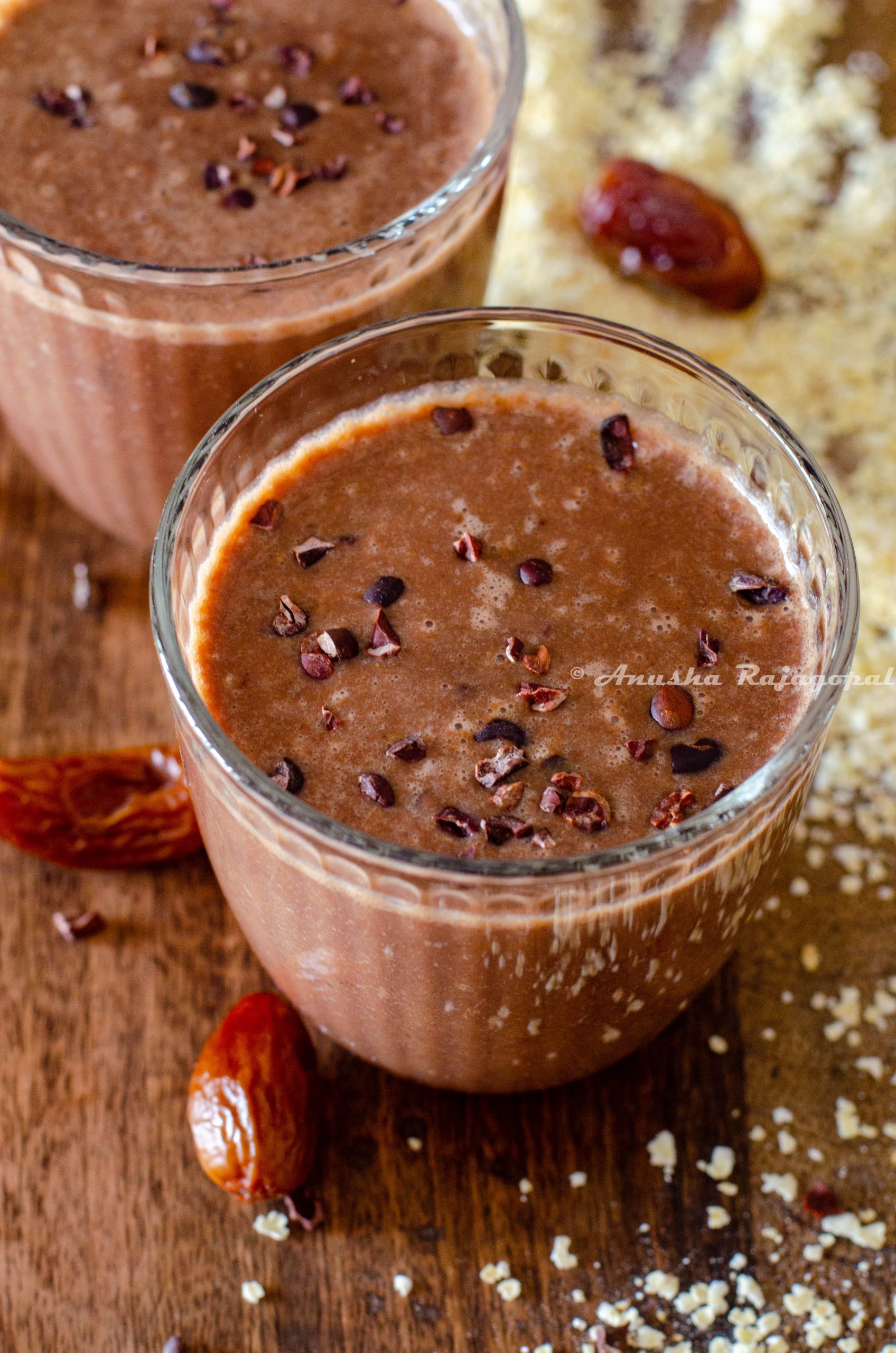 vegan coffee banana smoothie topped with cacao nibs and served in glasses