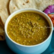 Instant pot green moong dal served in a blue bowl with rotis