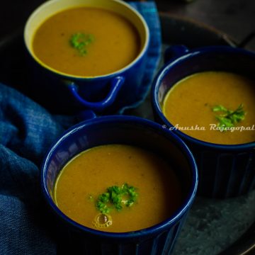 Moroccan red lentil soup served in blue soup bowls. Fresh parsley as a garnish on the top