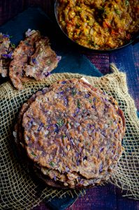 Ragi chapati with purple cabbage stacked and served with baingan bartha