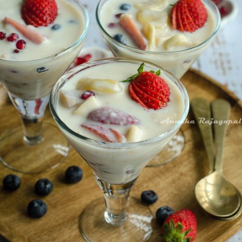fruit custard without custard powder served in glasses placed on a wooden plate