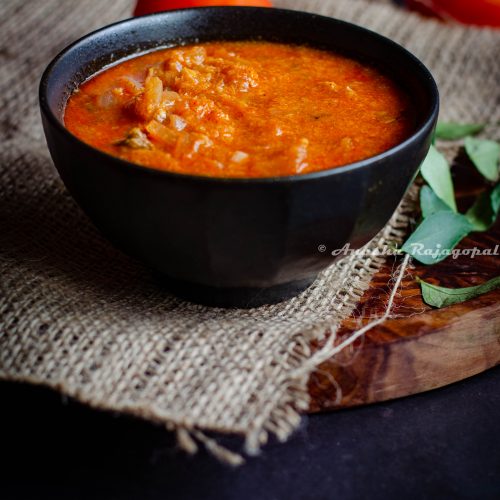 Tomato kurma, a south Indian curry served in a black bowl