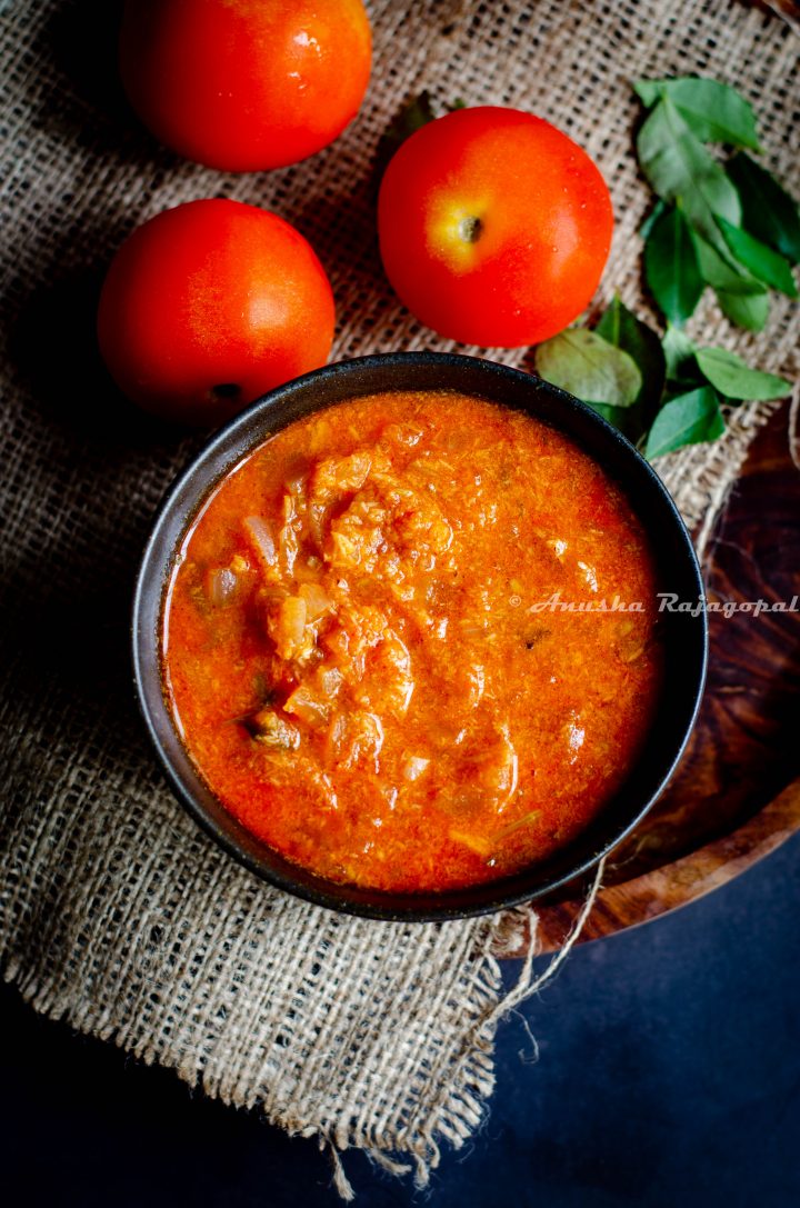 Tomato kurma, a south Indian curry served in a black bowl