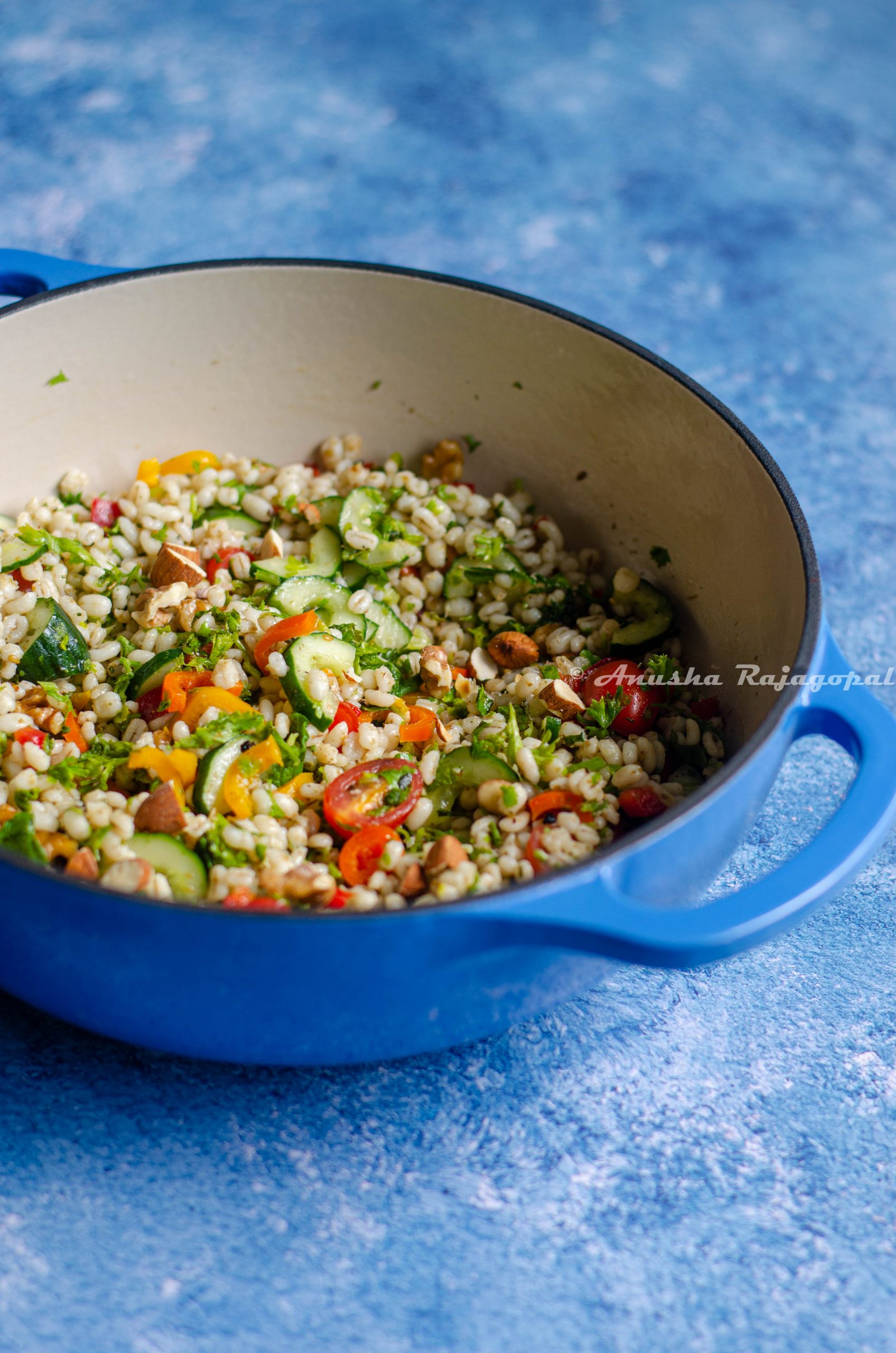 middle eastern barley salad served in a blue dutch oven