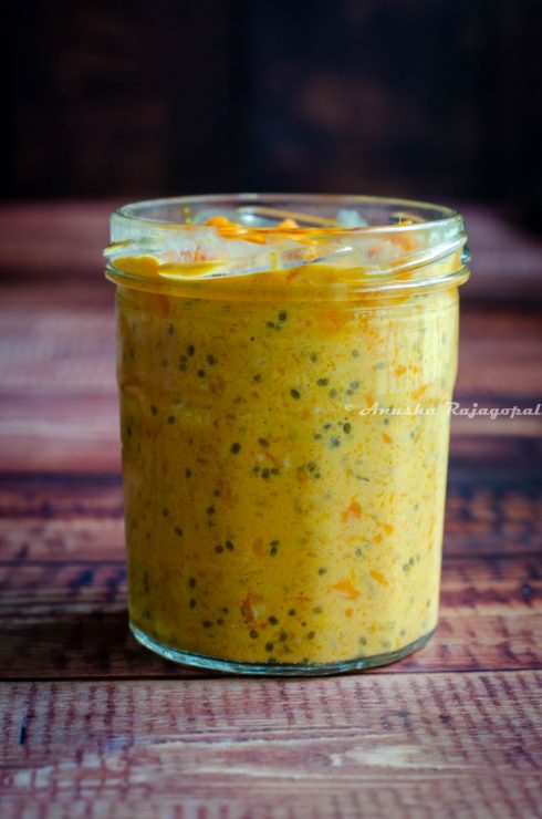 mango coconut overnight oats in a jar set against a brown backdrop
