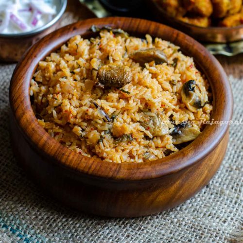 instant pot Jeera rice biryani served in a brown bowl placed on a burlap mat