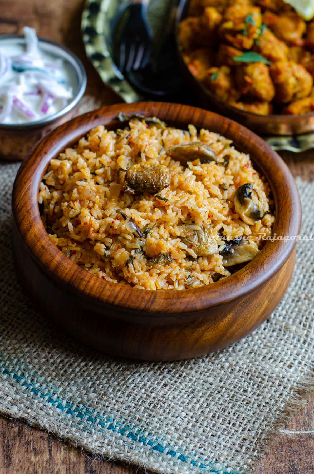 instant pot Jeera rice biryani served in a brown bowl placed on a burlap mat