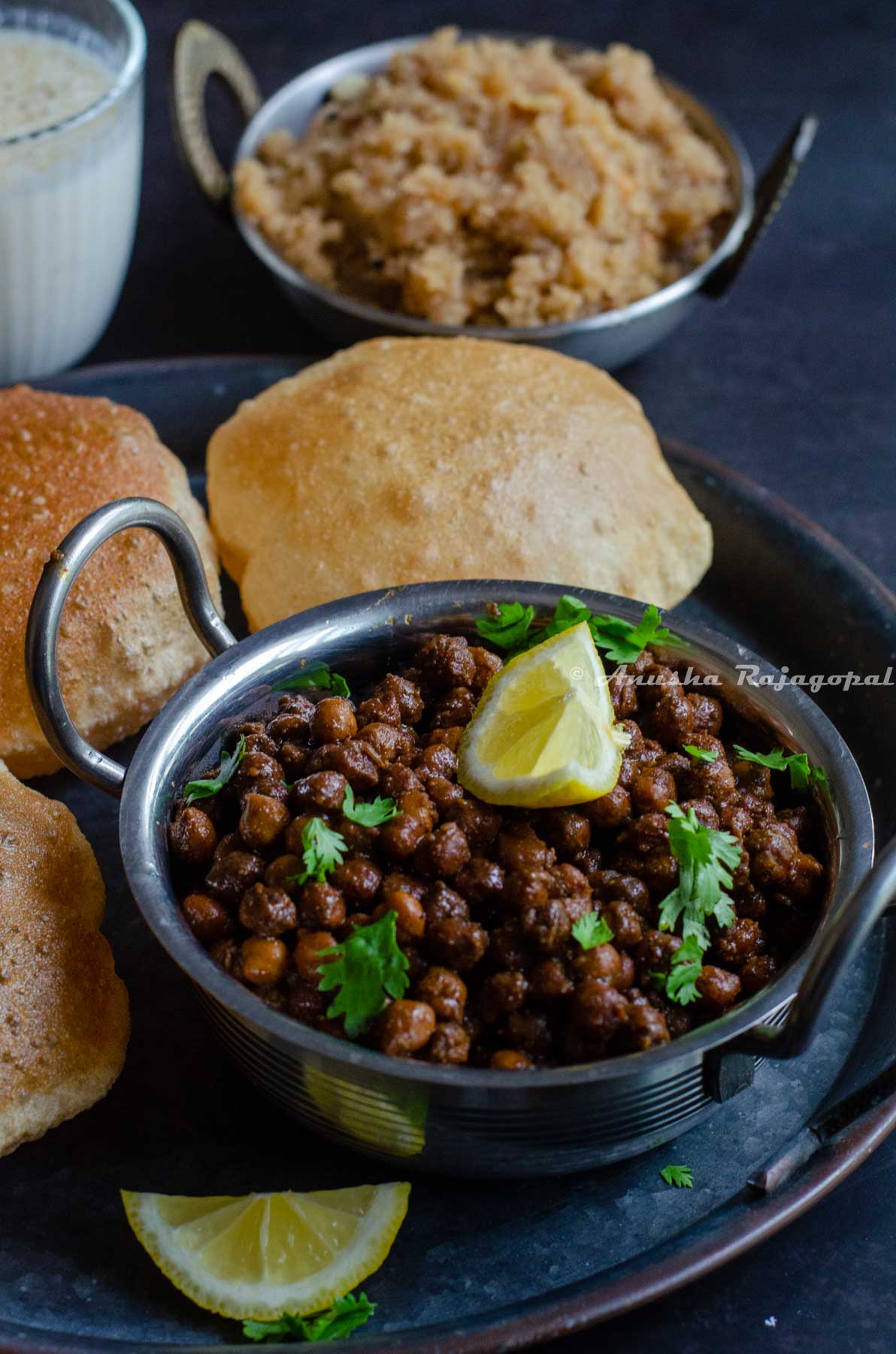 Kala chana ashtami prasad served in a platter with poori and sooji halwa