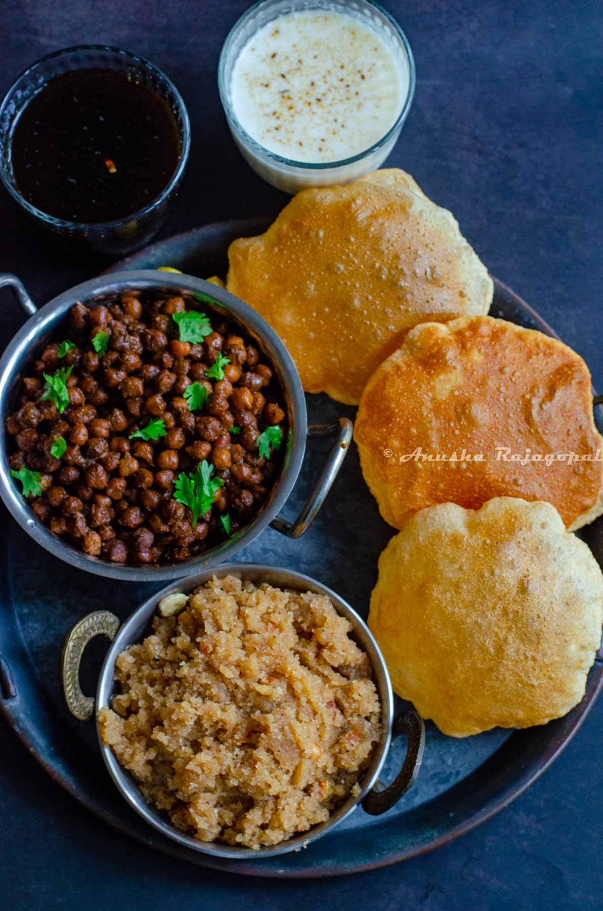 The Ashtami Prasad platter featuring sookhe Kala chana, sooji ka halwa, poori, chaas