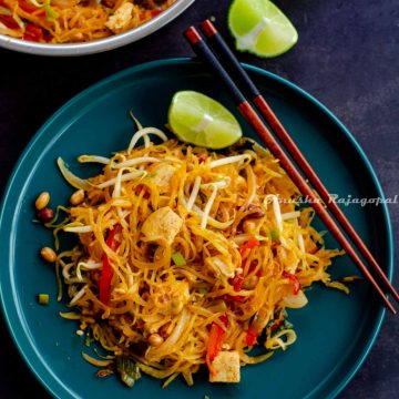 Spaghetti Squash Pad Thai served on a teal blue plate with a lime wedge and chopsticks