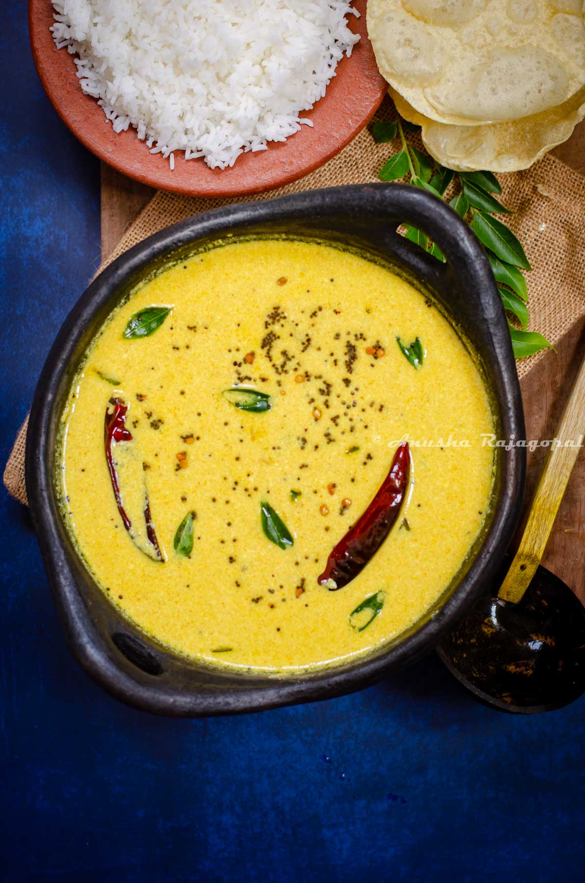 Kerala style mango curry in a yogurt base served in a blackened claypot. Served alongside steamed rice, poppadoms