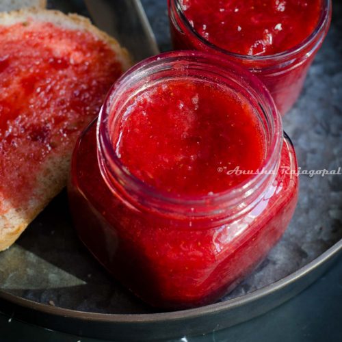 Easy strawberry jam without pectin in glass jars placed on a metal serving tray