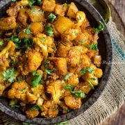 a-bowl-of-aloo-gobi-served-in-a-black-shallow-bowl
