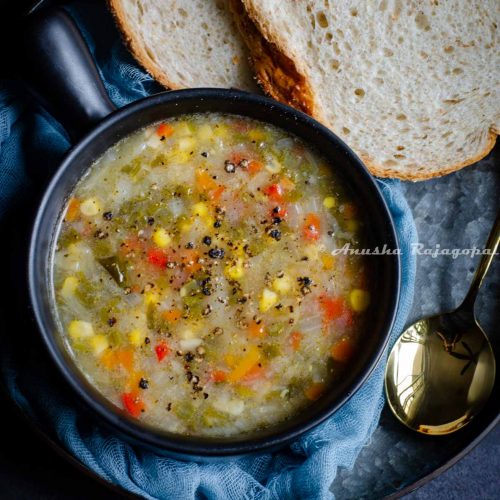 A bowl of Instant Pot vegetable soup and some bread