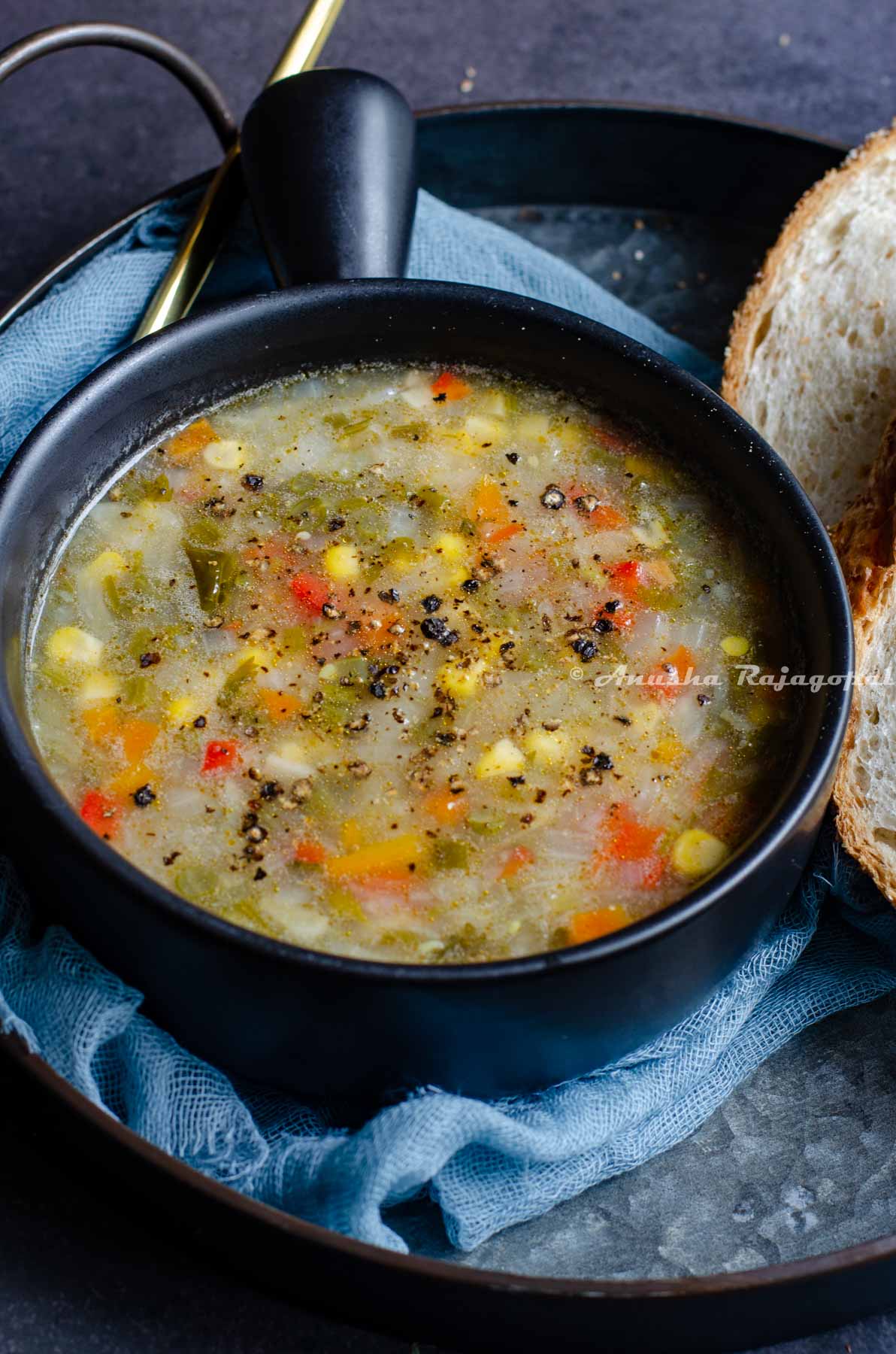 A bowl of nutritious soup with lots of fresh veggies