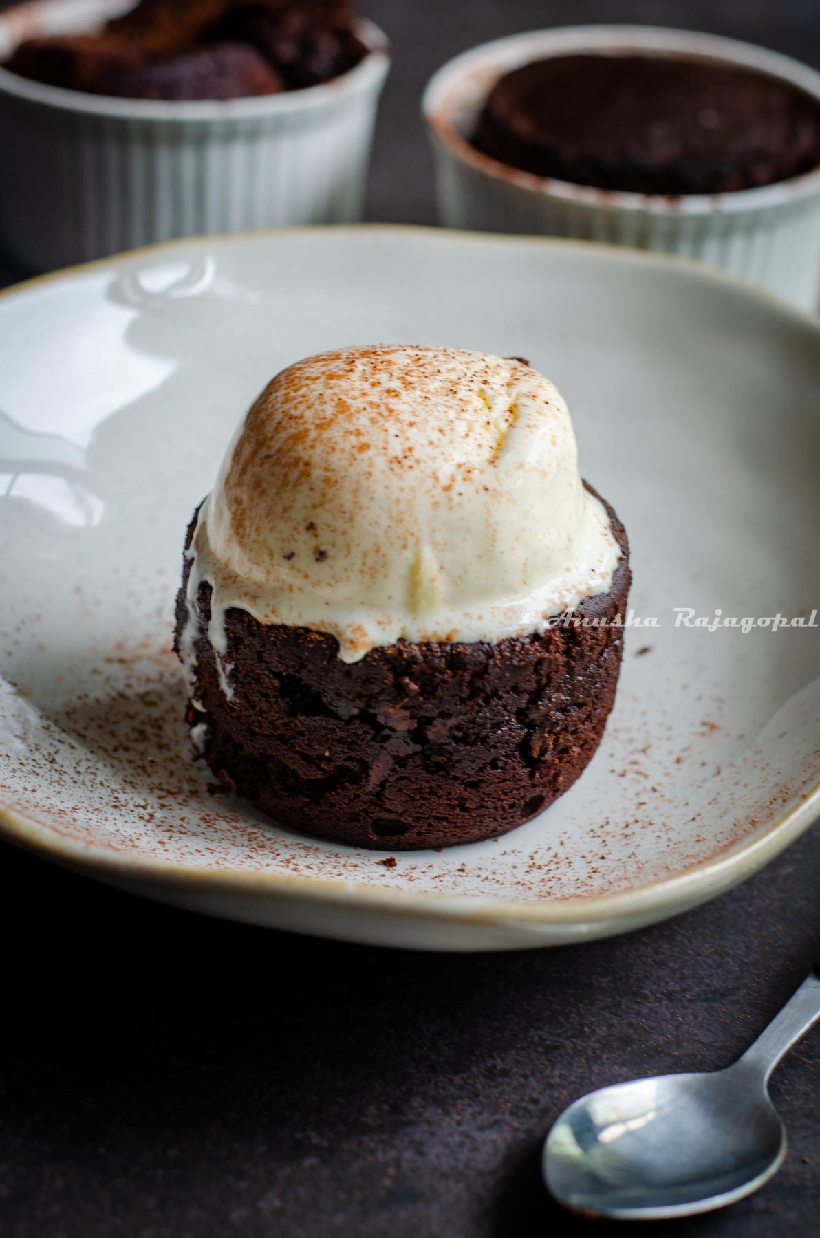 molten lava cupcake topped with vanilla ice cream