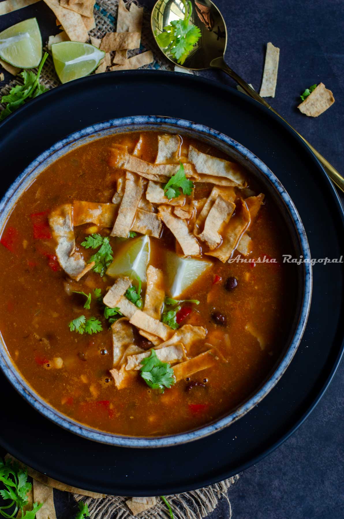 a bowl of vegan tortilla soup with black beans