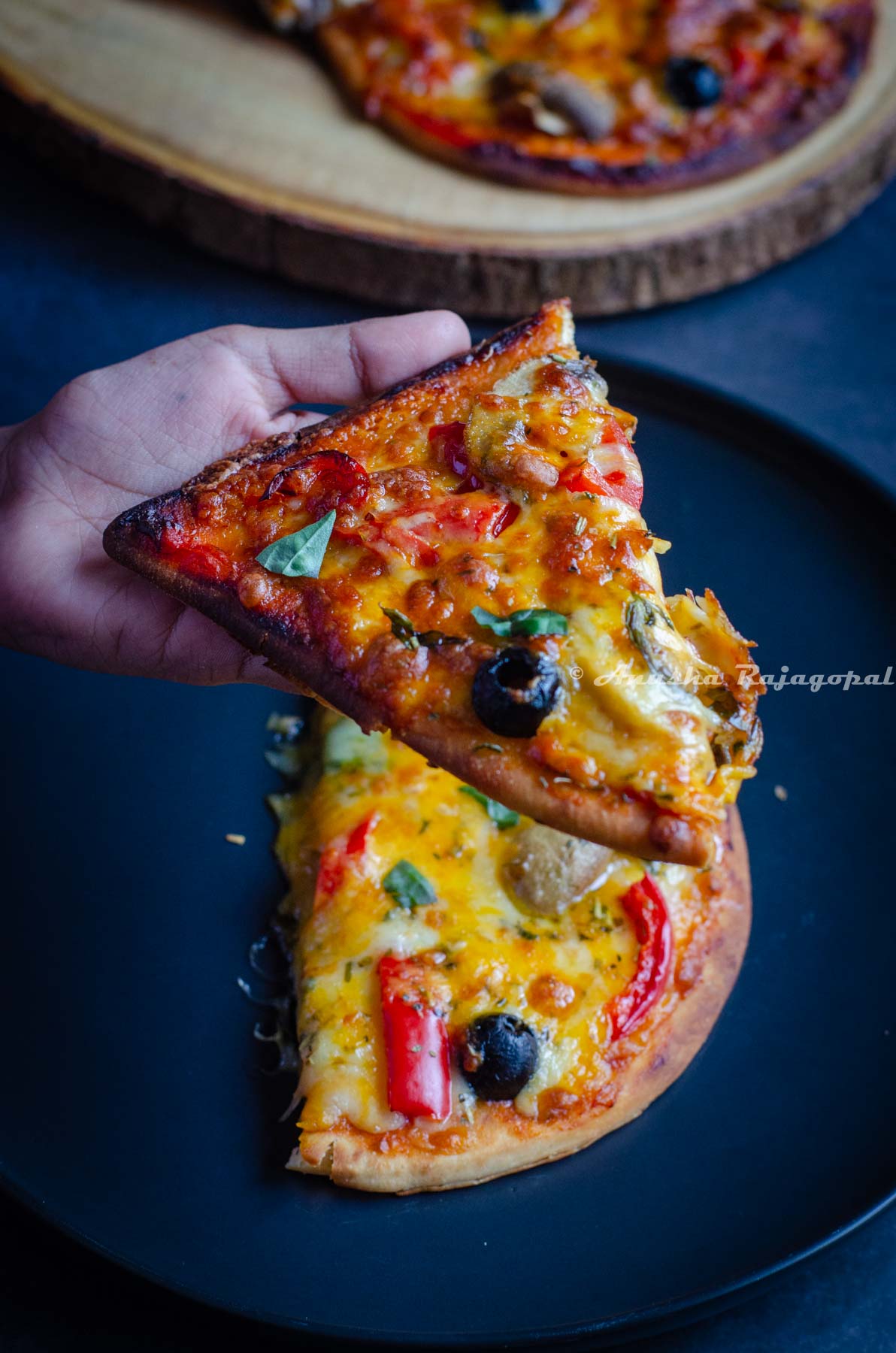 A slice of air fryer naan pizza up, close and center